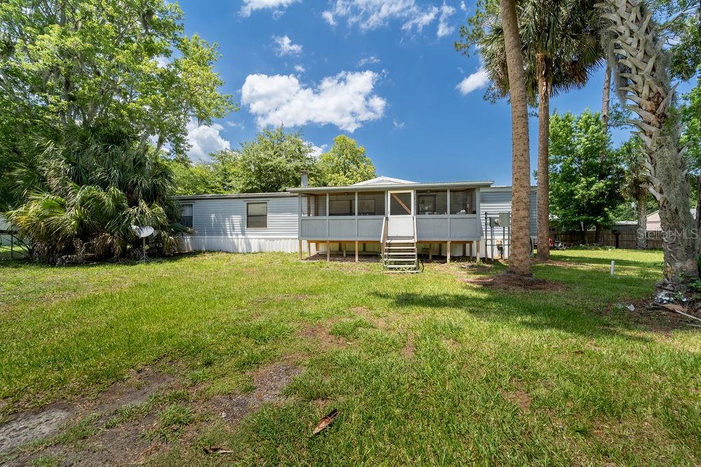 24031 Armadillo Road Astor, FL 32102 - Photo 1 of 43 a house view with a garden space