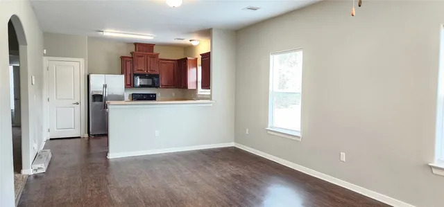 a kitchen with stainless steel appliances granite countertop a refrigerator and a sink