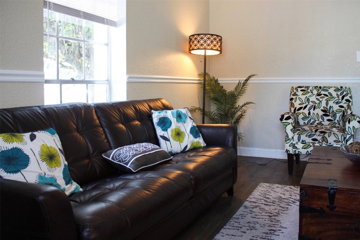9407 Westheimer Road, Unit 305 Houston, TX 77063 - Photo 3 of 10 a living room with a couch and a potted plant