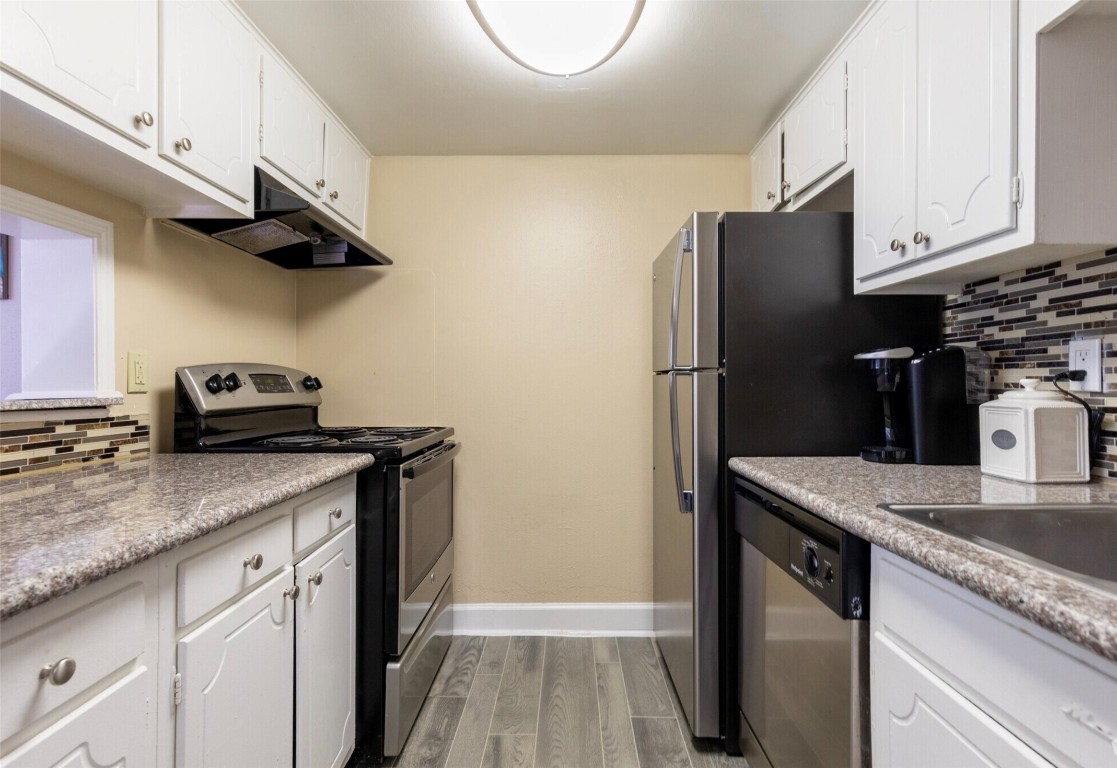 9407 Westheimer Road, Unit 305 Houston, TX 77063 - Photo 4 of 10 a kitchen with stainless steel appliances granite countertop a refrigerator a sink and a stove