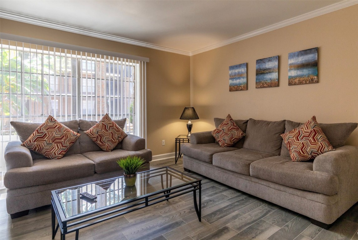 9407 Westheimer Road, Unit 305 Houston, TX 77063 - Photo 6 of 10 a living room with furniture and a large window