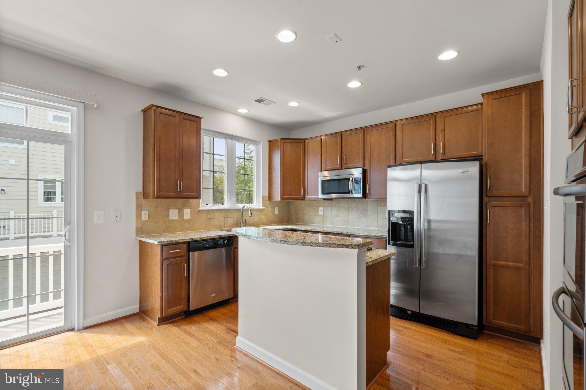 11669 Leesborough Circle Silver Spring, MD 20902 - Photo 13 of 46 a kitchen with stainless steel appliances granite countertop a refrigerator a stove top oven a sink and dishwasher