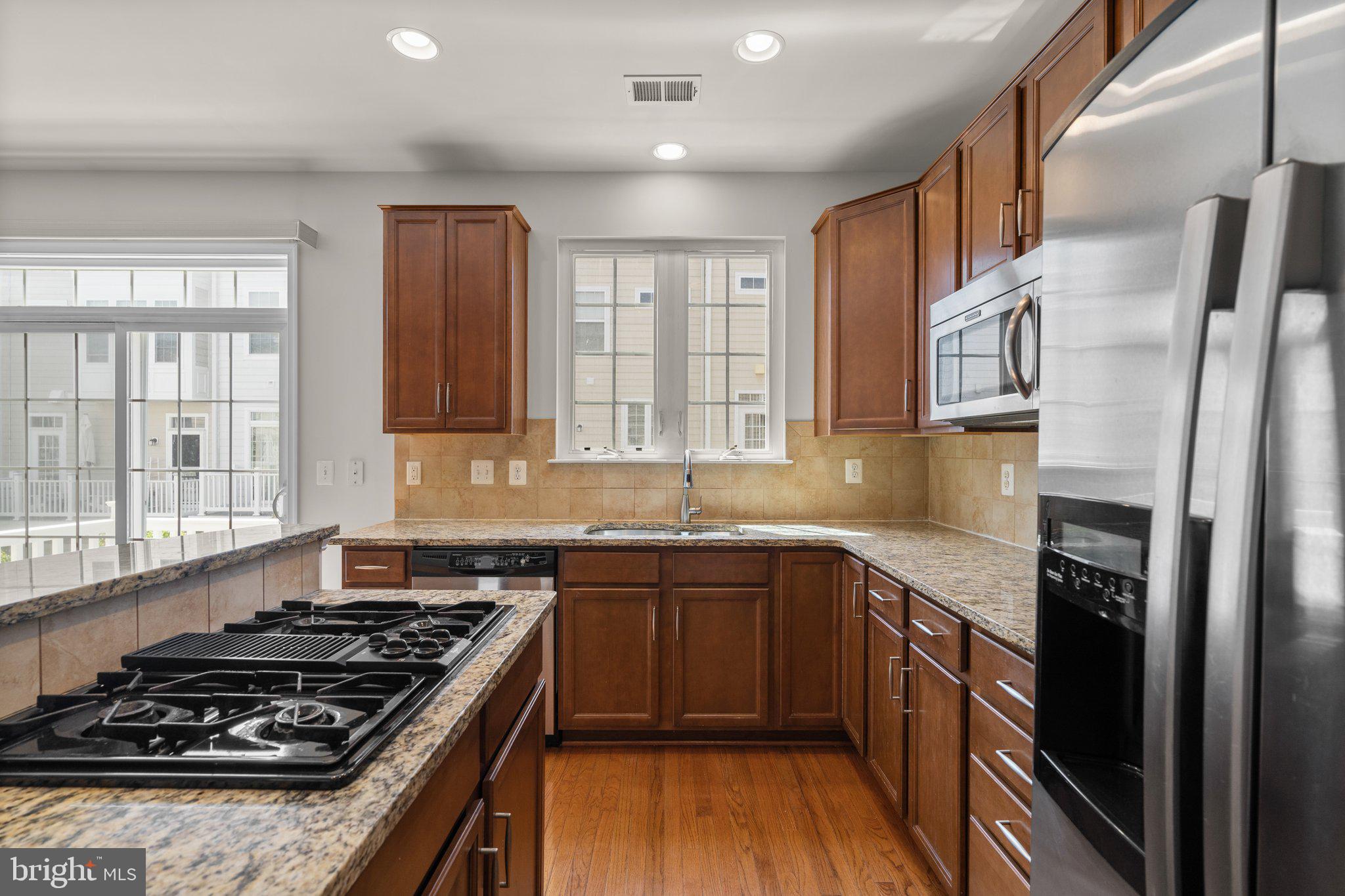 11669 Leesborough Circle Silver Spring, MD 20902 - Photo 14 of 46 a kitchen with stainless steel appliances granite countertop a stove and a sink