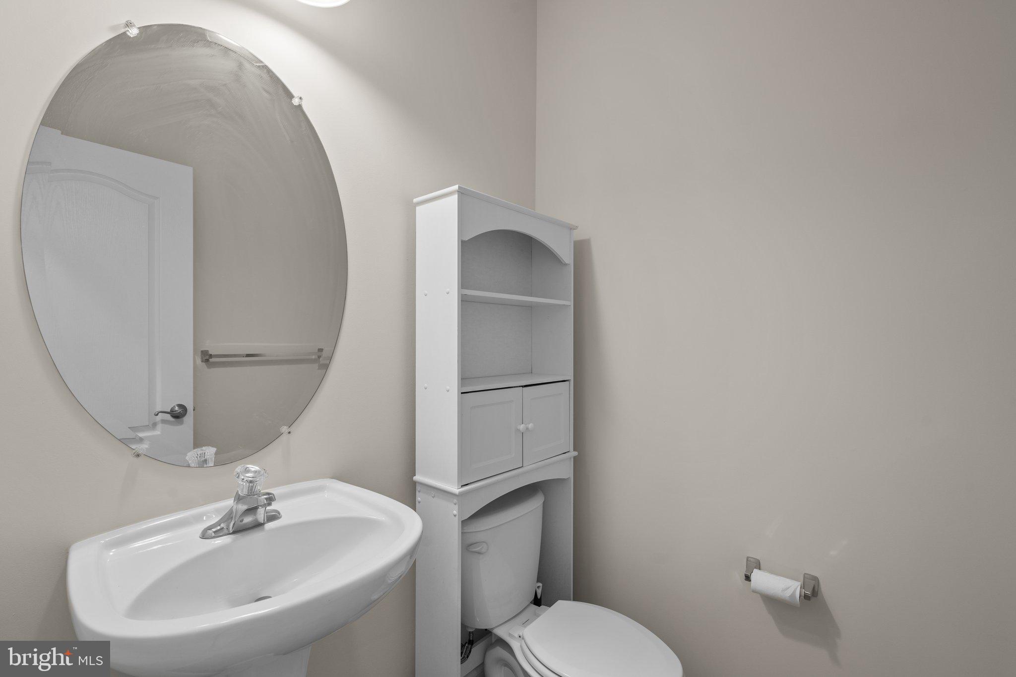 11669 Leesborough Circle Silver Spring, MD 20902 - Photo 18 of 46 a bathroom with a toilet sink and mirror