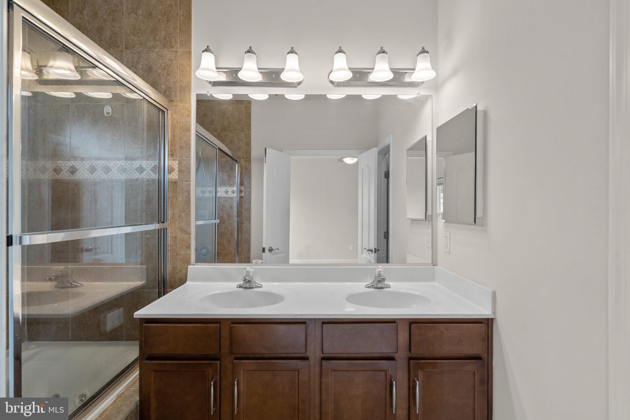 11669 Leesborough Circle Silver Spring, MD 20902 - Photo 24 of 46 a bathroom with a sink and a mirror