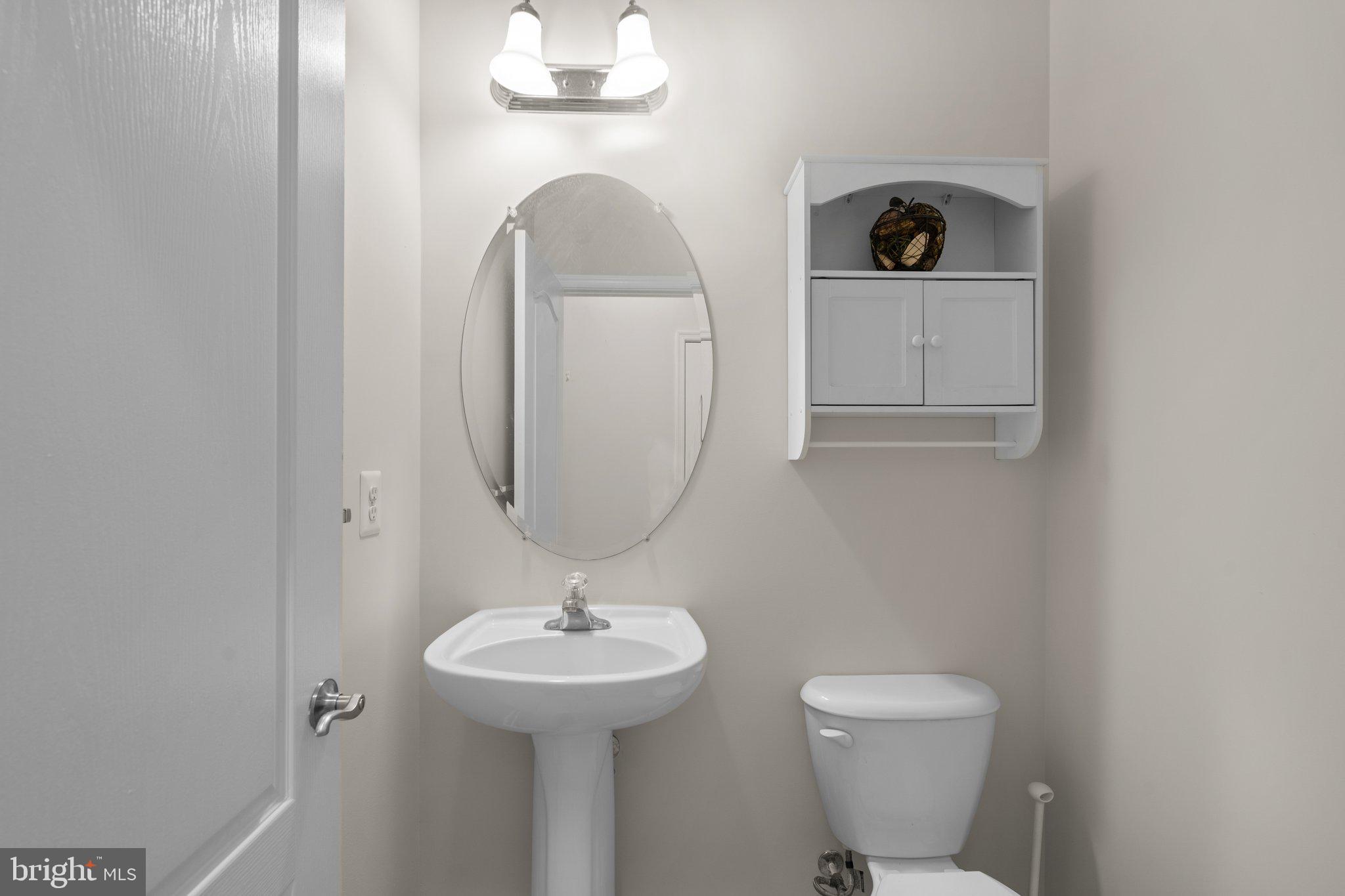 11669 Leesborough Circle Silver Spring, MD 20902 - Photo 41 of 46 a bathroom with a toilet a sink and mirror