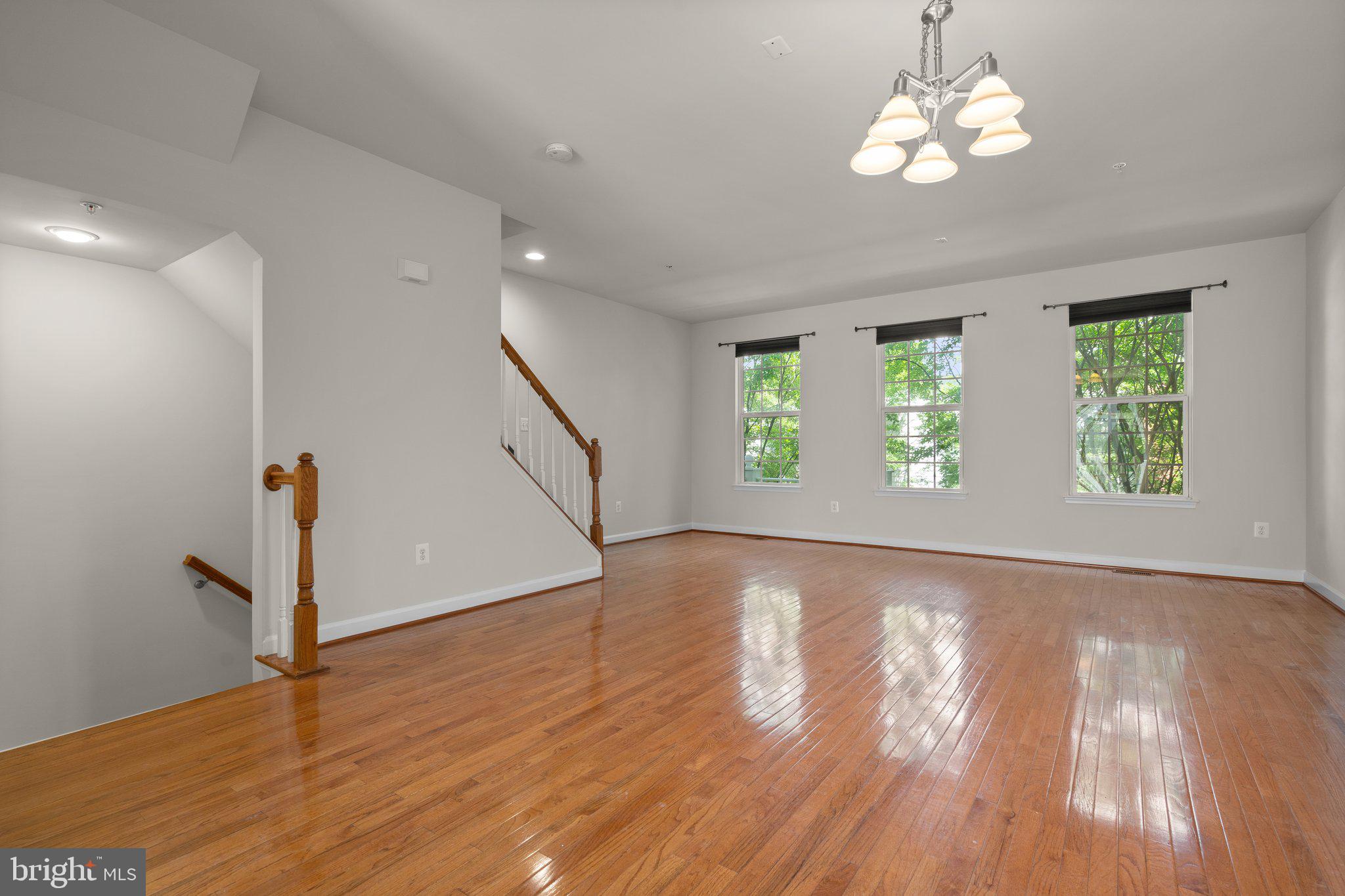 11669 Leesborough Circle Silver Spring, MD 20902 - Photo 5 of 46 a view of an empty room with wooden floor and a window