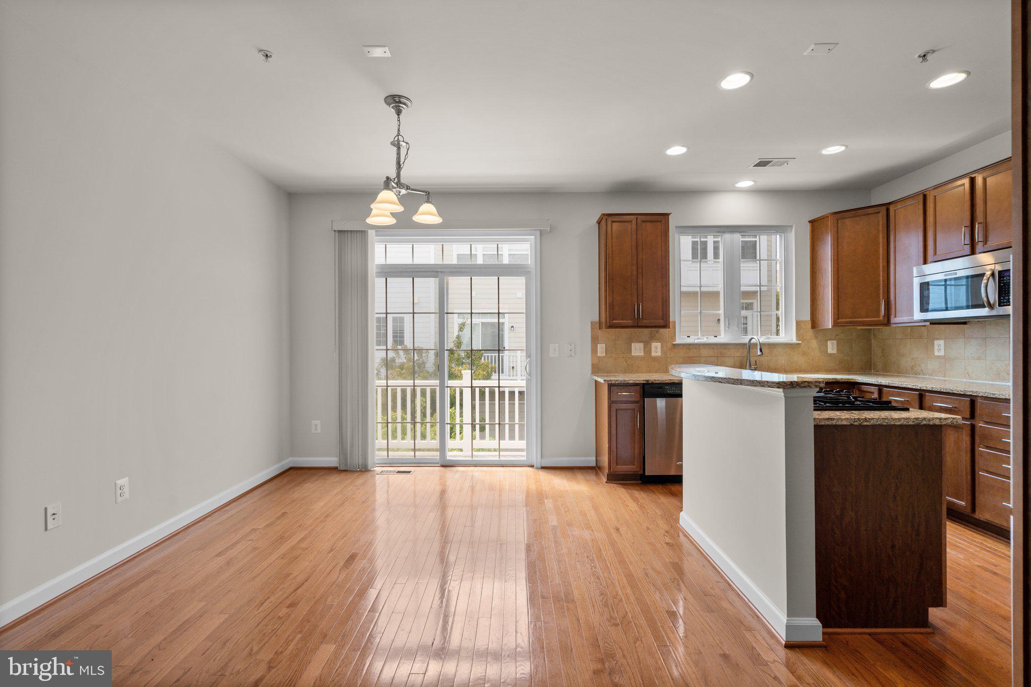 11669 Leesborough Circle Silver Spring, MD 20902 - Photo 7 of 46 a kitchen with stainless steel appliances granite countertop a refrigerator a stove top oven a sink dishwasher and white cabinets with wooden floor