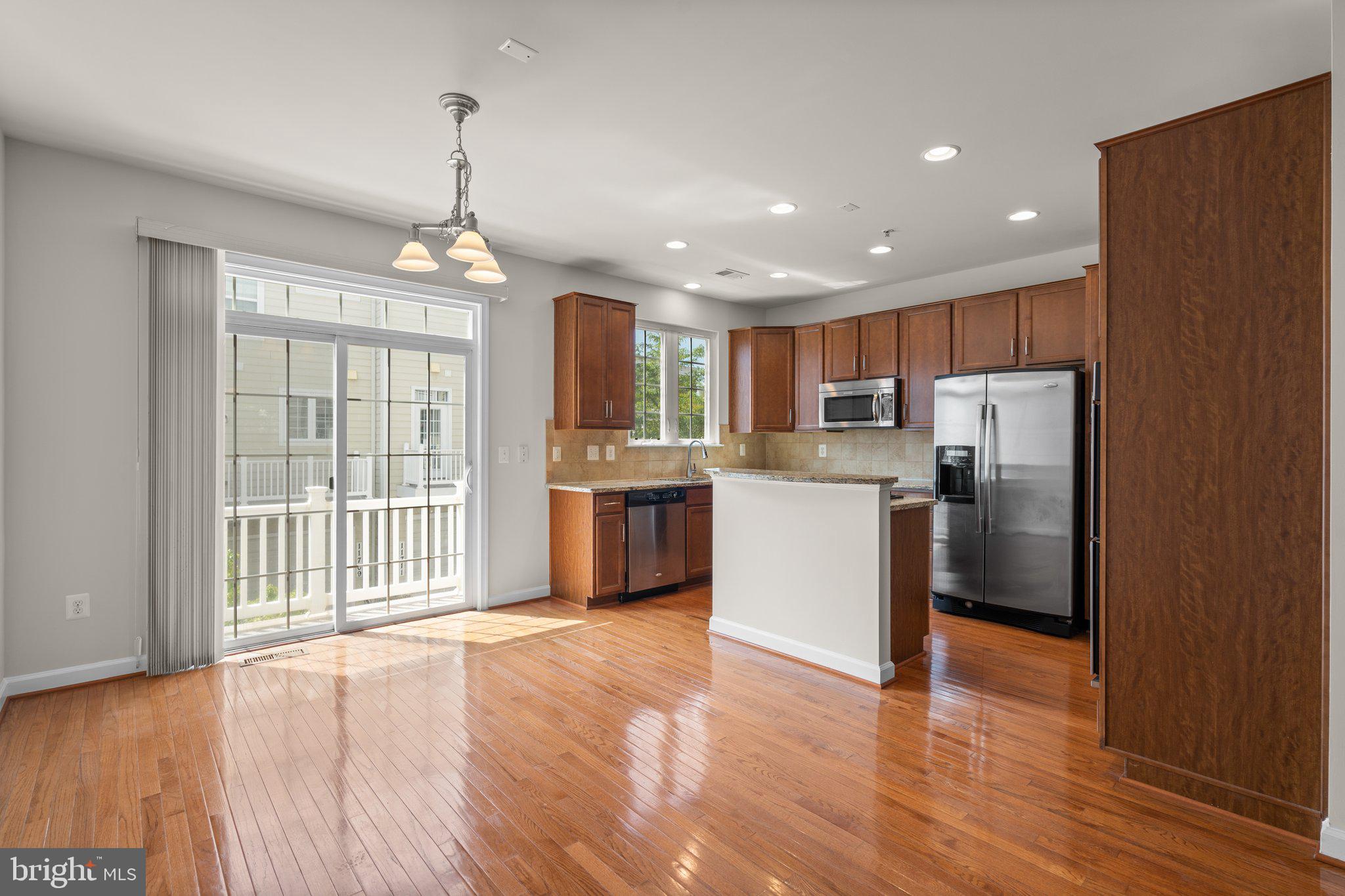 11669 Leesborough Circle Silver Spring, MD 20902 - Photo 8 of 46 a kitchen with stainless steel appliances granite countertop a refrigerator a stove top oven a sink and a wooden floor
