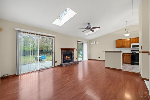 a view of a room with wooden floor and a fireplace