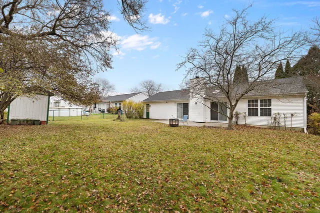 a front view of a house with a yard and trees
