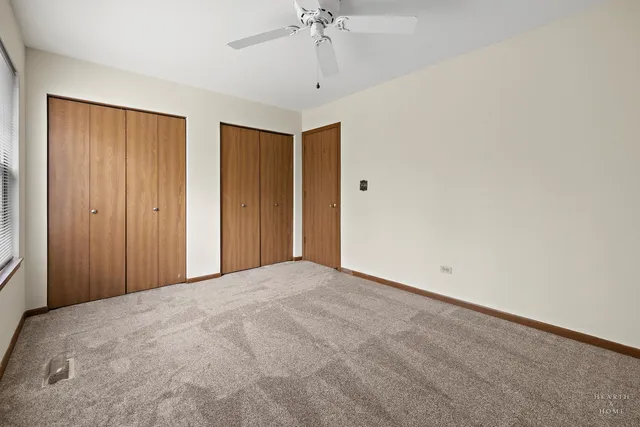 a view of a room with a ceiling fan