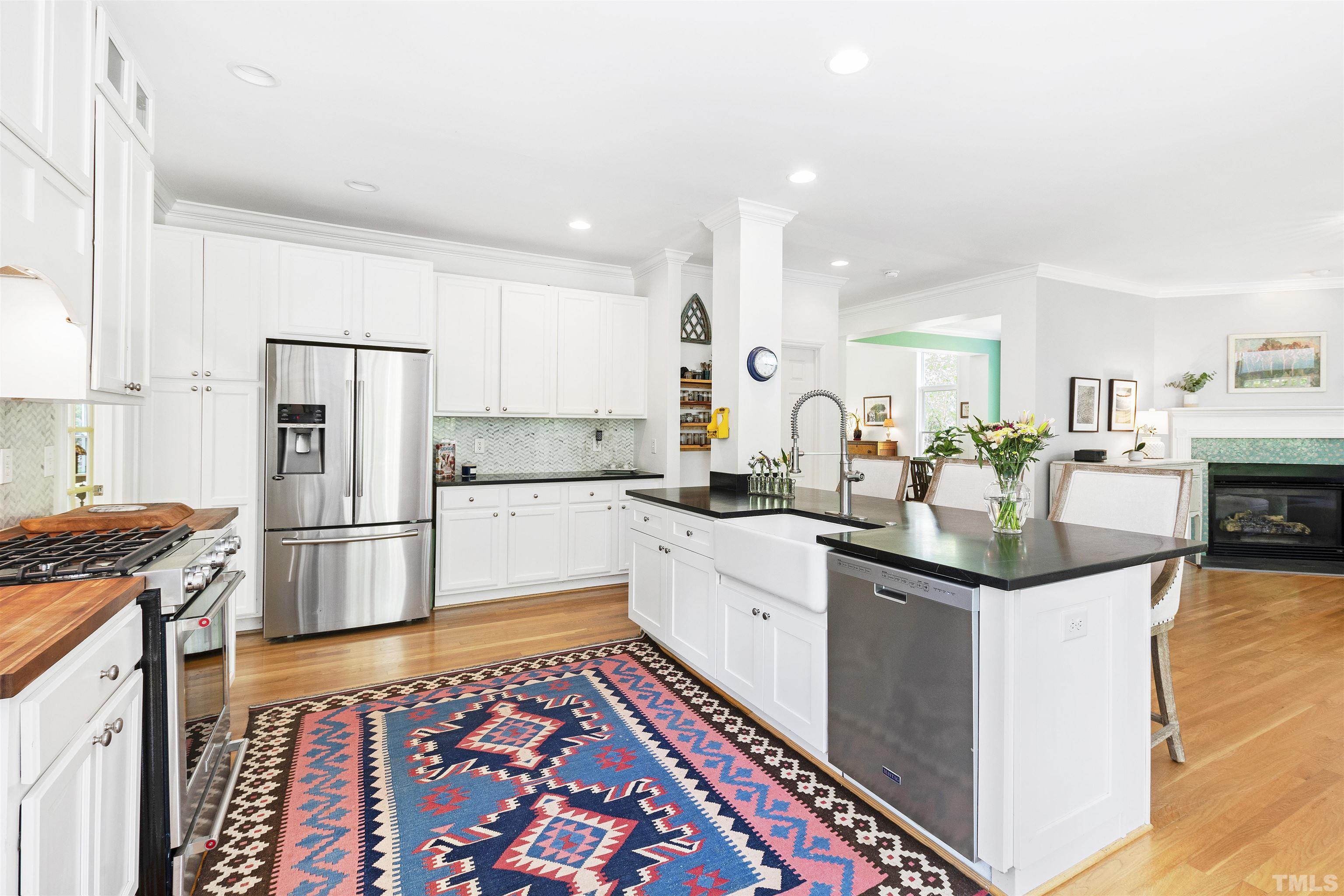 7039 Calais Drive Durham, NC 27712 - Photo 11 of 33 a kitchen with stainless steel appliances granite countertop a refrigerator and a stove top oven