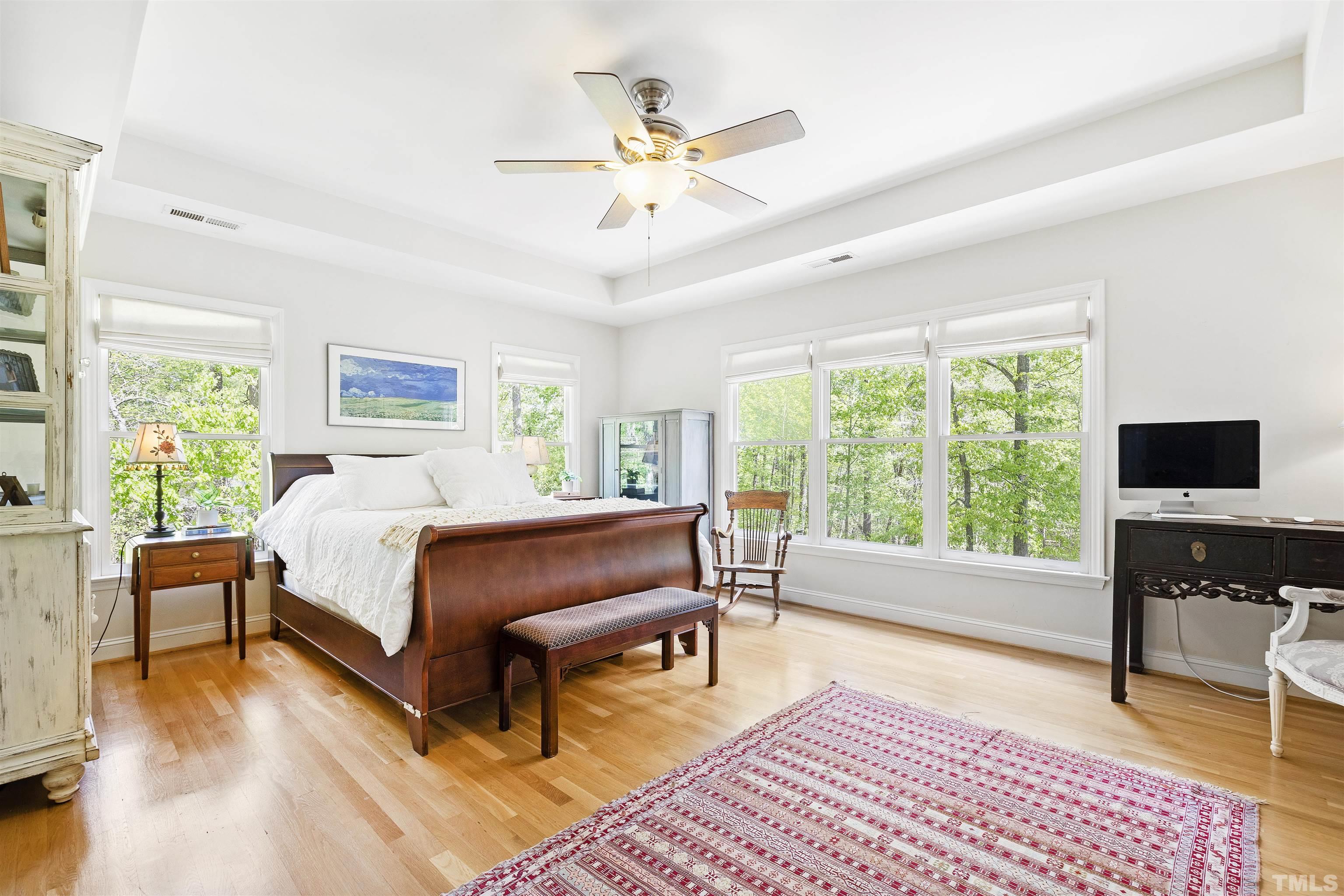 7039 Calais Drive Durham, NC 27712 - Photo 20 of 33 a spacious bedroom with a bed a couch and a window