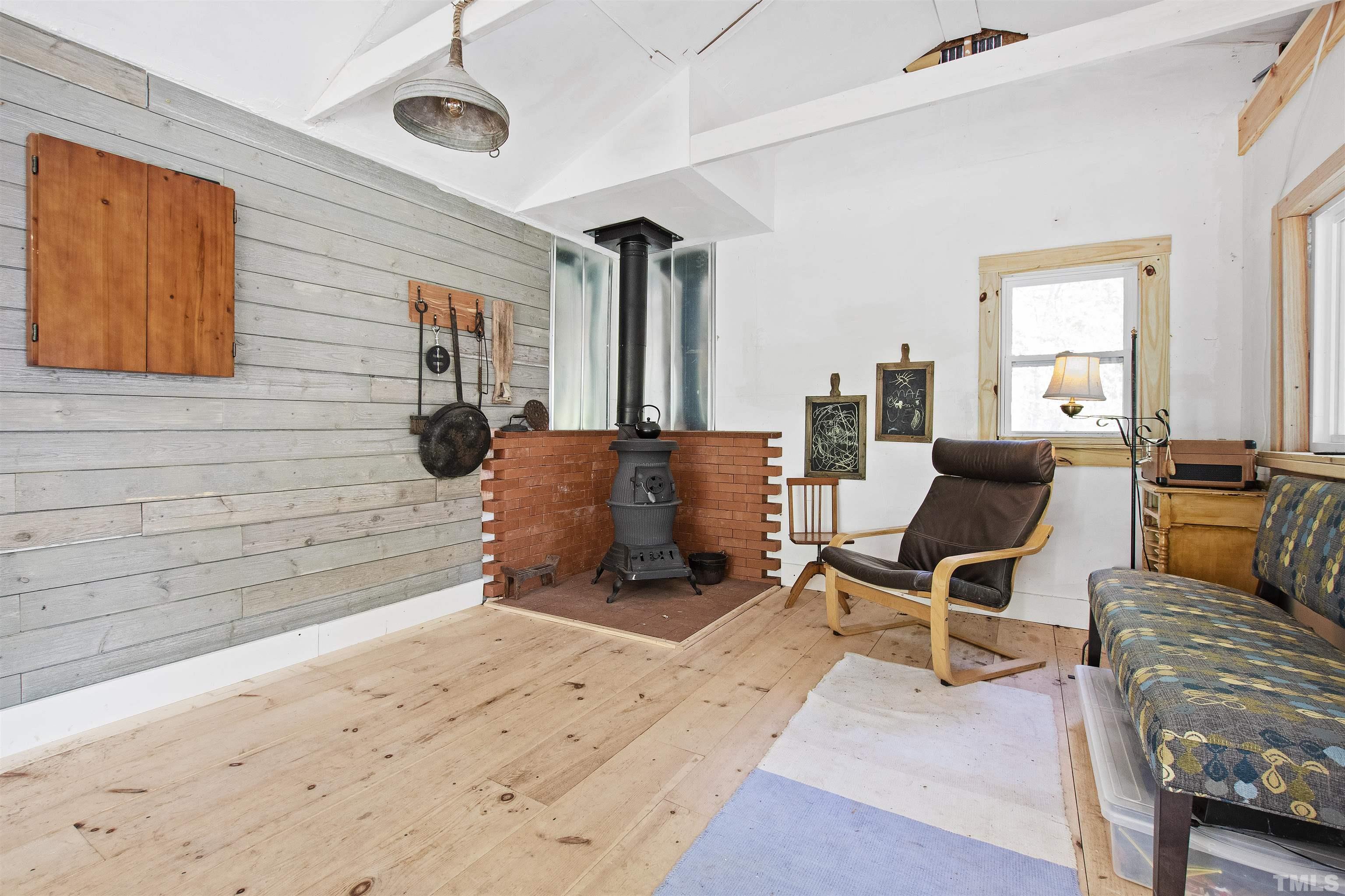 7039 Calais Drive Durham, NC 27712 - Photo 30 of 33 a living room with furniture and a flat screen tv