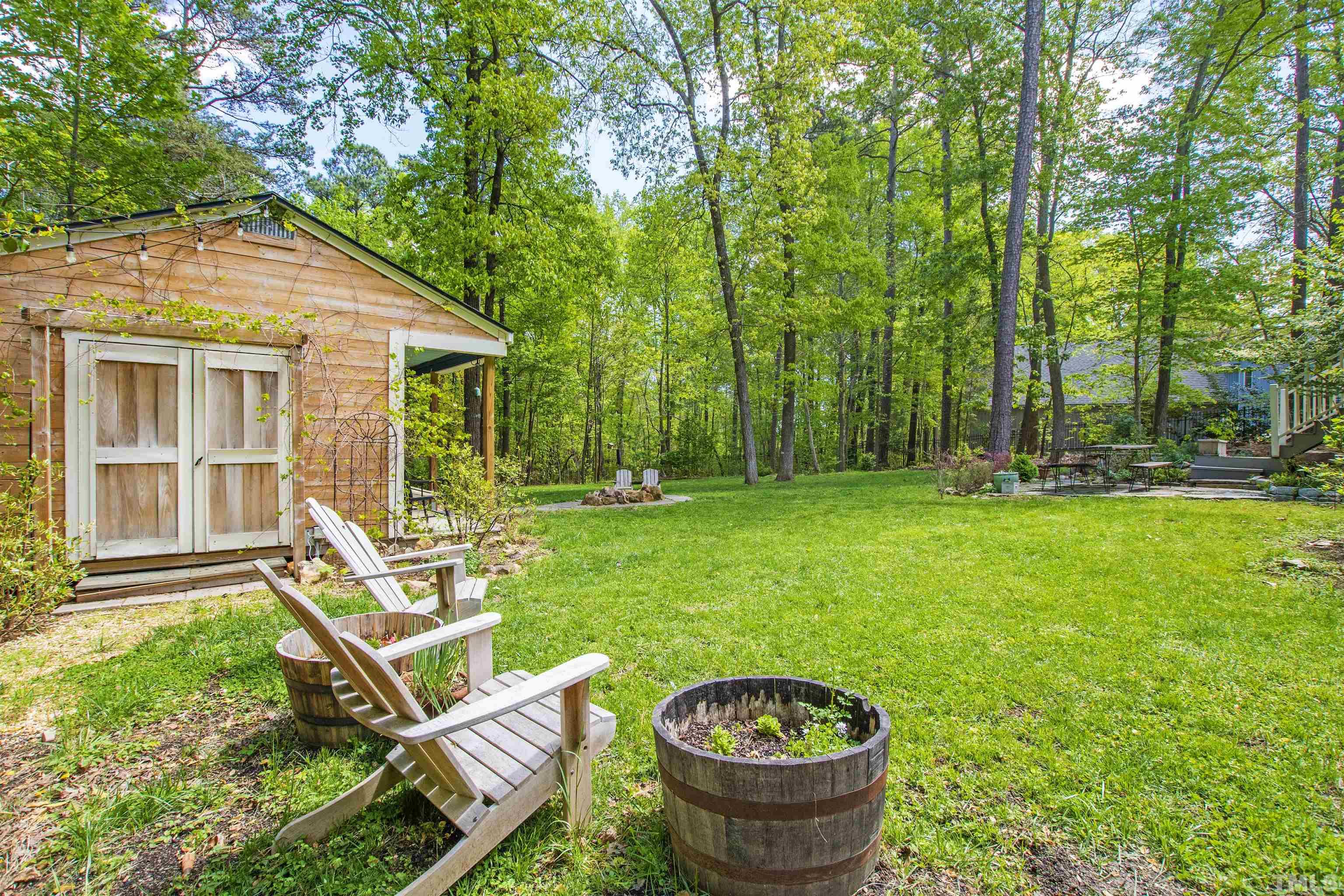 7039 Calais Drive Durham, NC 27712 - Photo 5 of 33 a view of a backyard with table and chairs and potted plants