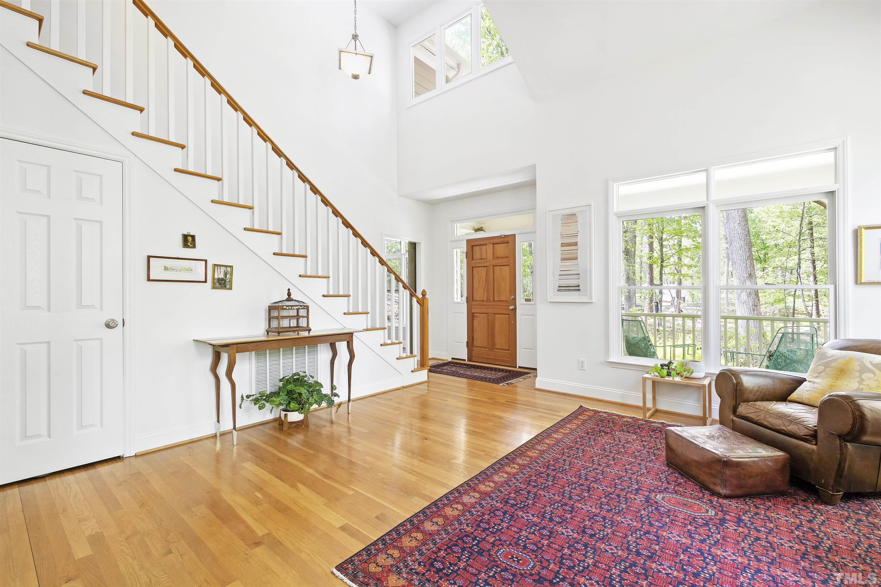 7039 Calais Drive Durham, NC 27712 - Photo 8 of 33 a living room with furniture and stairs with wooden floor
