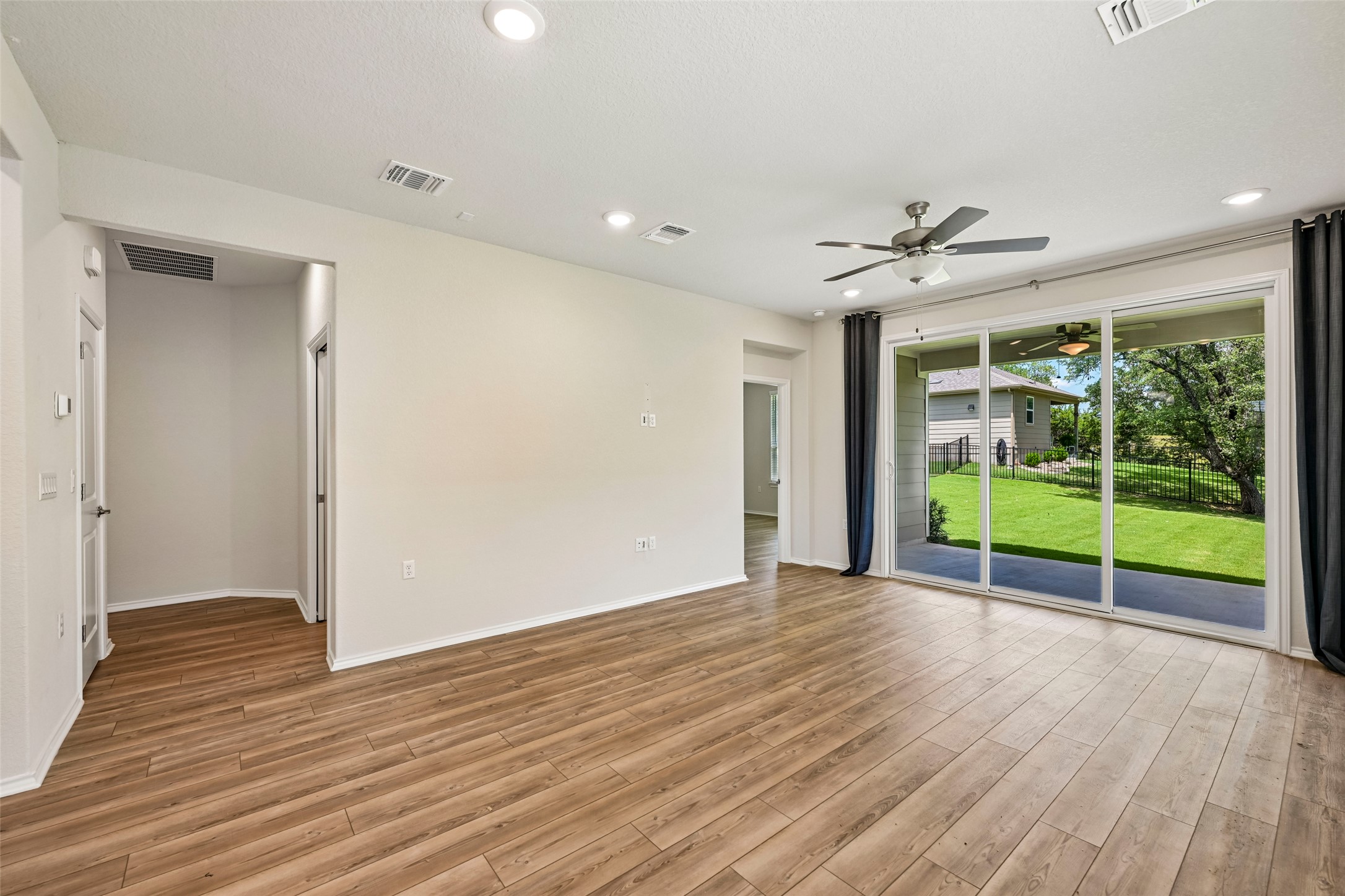 401 Yorktown Street Georgetown, TX 78633 - Photo 17 of 38 Spacious room with wood-finish flooring, recessed lighting, and a contemporary ceiling fan