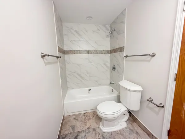 a bathroom with a toilet and a shower