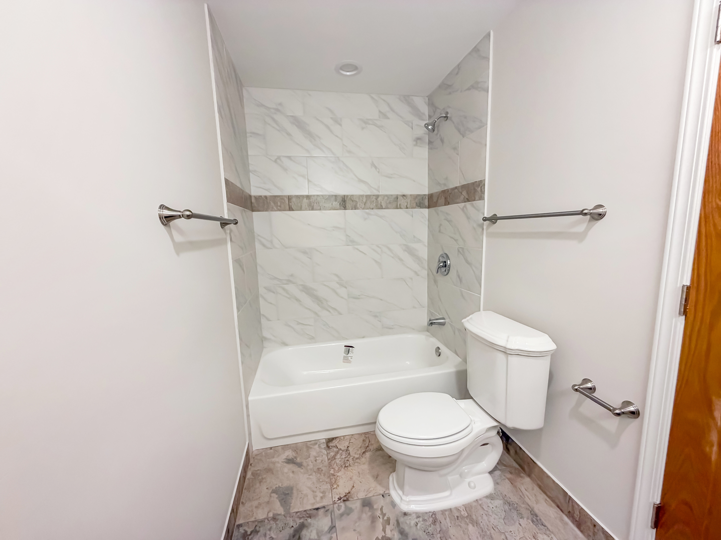 6415 West Irving Park Road, Unit 2S Chicago, IL 60634 - Photo 5 of 11 a bathroom with a toilet and a shower