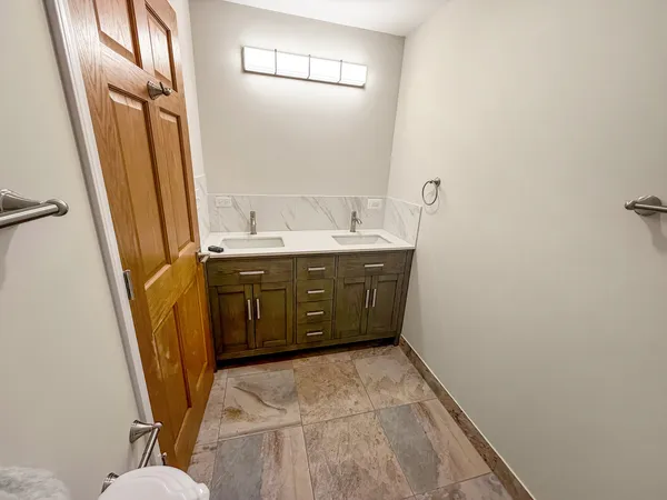 a bathroom with a sink a toilet a mirror and a tub