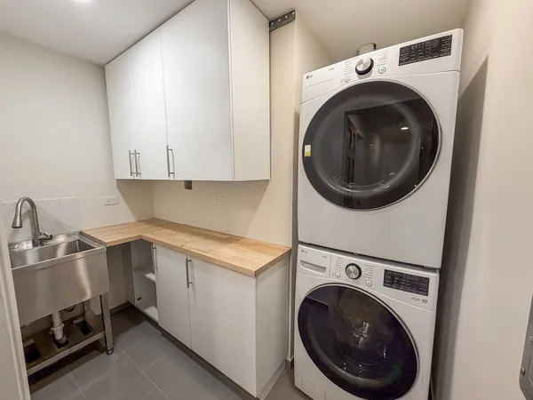 a utility room with sink dryer and washer