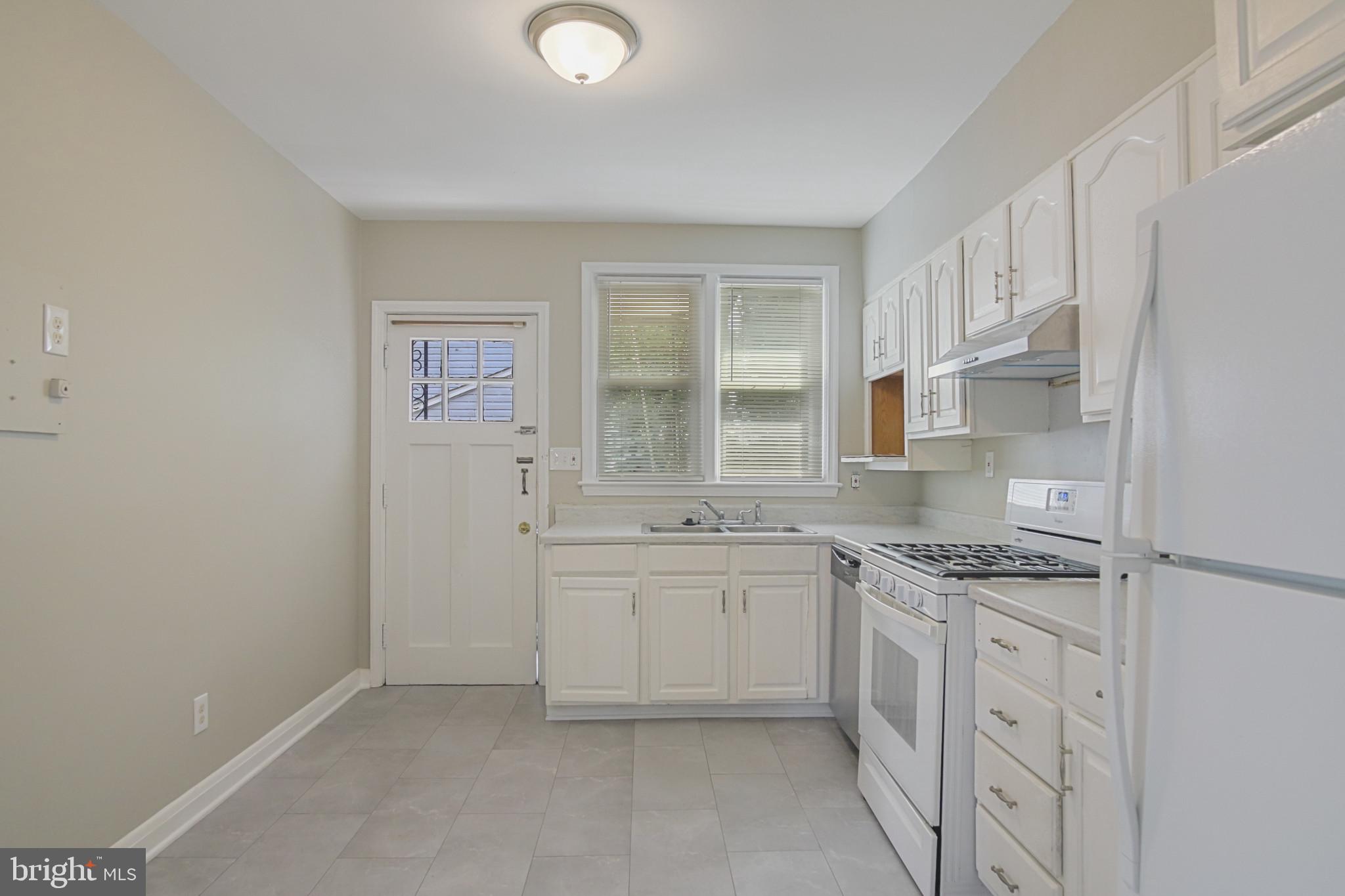 608 Farmhurst Road Baltimore, MD 21208 - Photo 17 of 45 a kitchen with stainless steel appliances granite countertop a sink and dishwasher a stove top oven with white cabinets