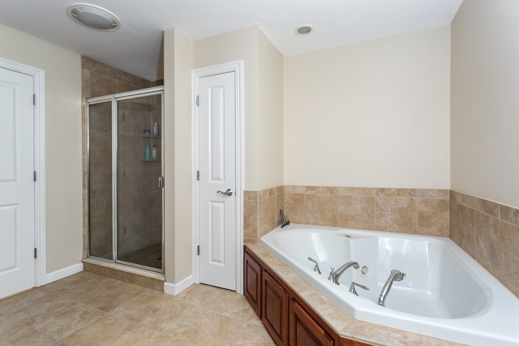 49 Beaver Street, Unit 49 Franklin, MA 02038 - Photo 19 of 46 a bathroom with a tub and shower