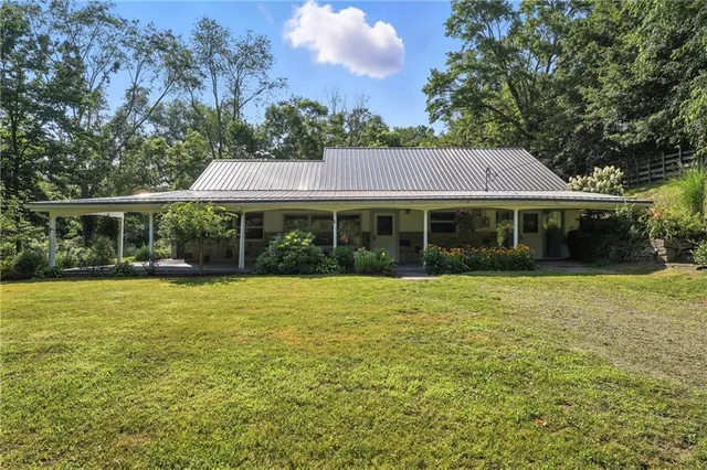 a front view of a house with a garden