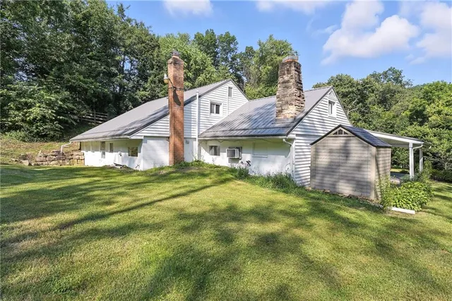 a house with swimming pool in front of it