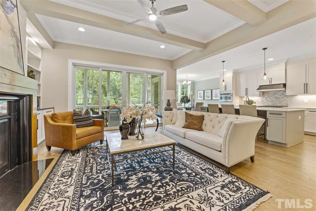 11007 Crest Mist Circle Raleigh, NC 27613 - Photo 30 of 30 A view of the open floor plan of the family room to the kitchen and breakfast room. The natural gas fireplace has a black granite surround with stained wood mantel.