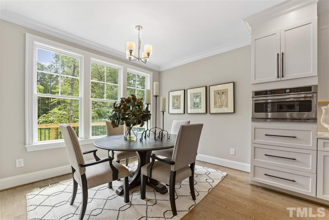 11007 Crest Mist Circle Raleigh, NC 27613 - Photo 14 of 30 The breakfast room is light-filled. There is a door to the screened porch in addition to the sliders in the family room. The cabinet configuration in the home offers a nice blend of drawers and cabinets.