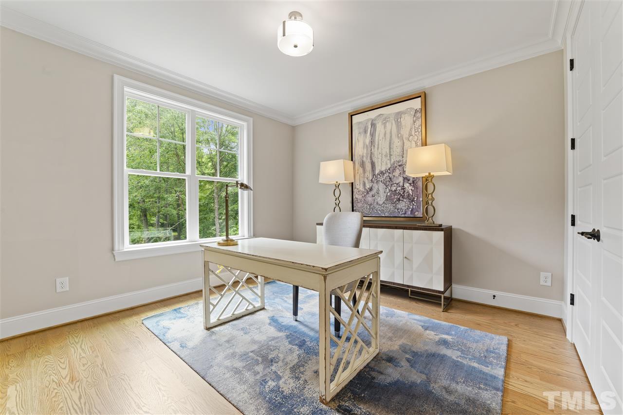 11007 Crest Mist Circle Raleigh, NC 27613 - Photo 15 of 30 The first floor guest suite is staged here as an office, but can be used as a bedroom as well. There is a double closet and access to the full bath with walk in shower. This bedroom is on the opposite side of the home from the master for privacy.