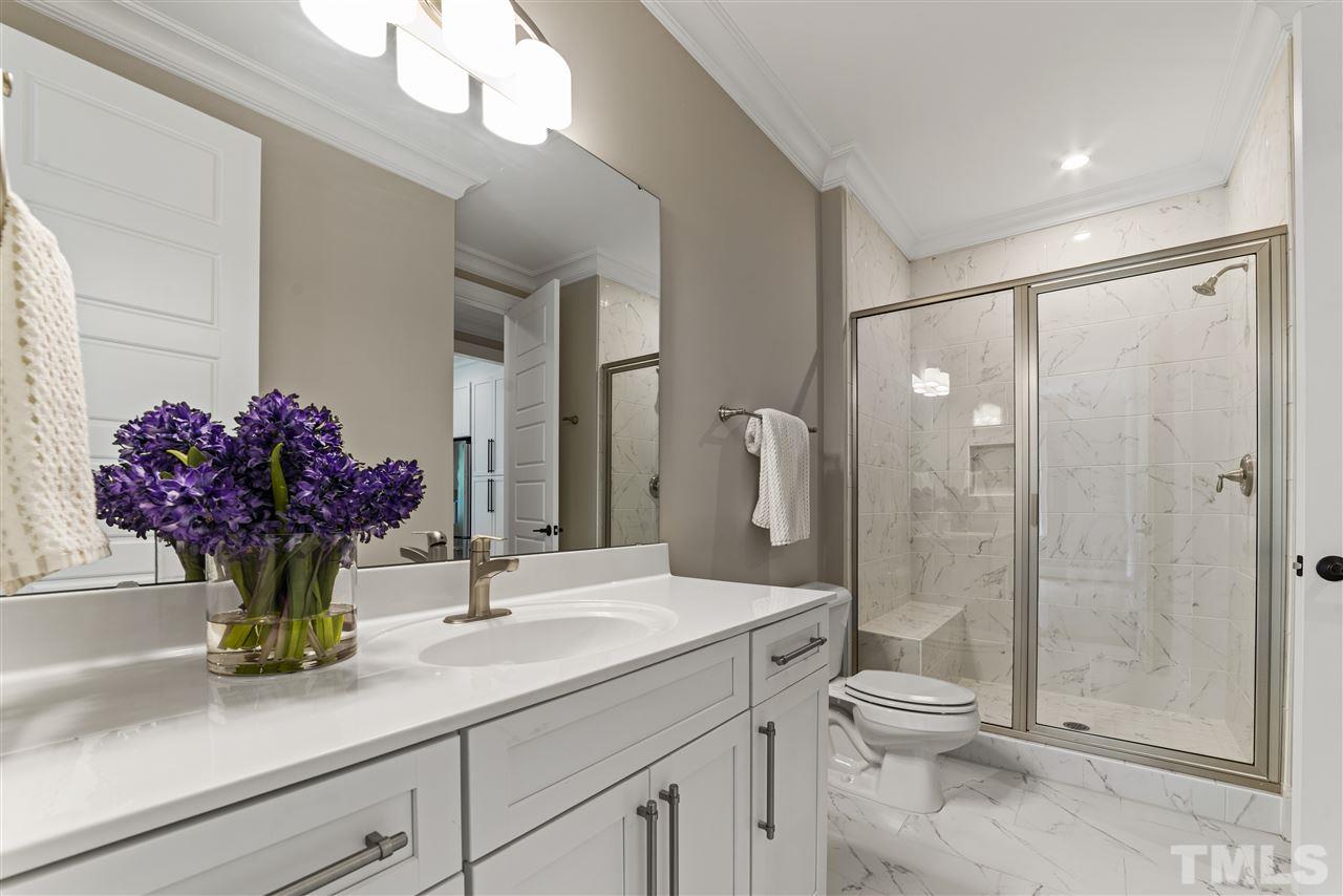 11007 Crest Mist Circle Raleigh, NC 27613 - Photo 16 of 30 The main floor bathroom has a walk in shower and large vanity.