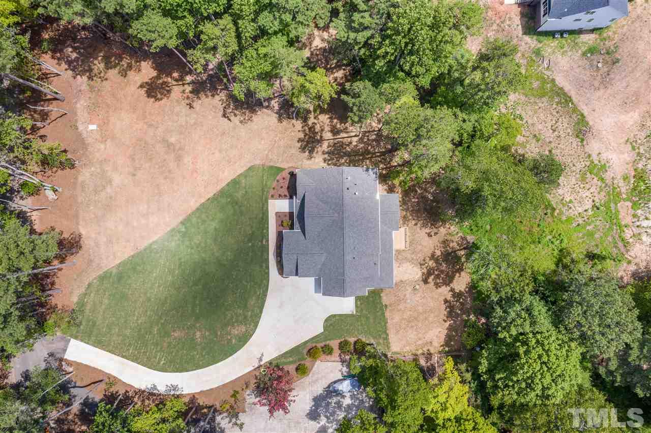 11007 Crest Mist Circle Raleigh, NC 27613 - Photo 3 of 30 The drone view from above gives you a picture of the home on the lot. A nice blend of trees, grass and natural space.