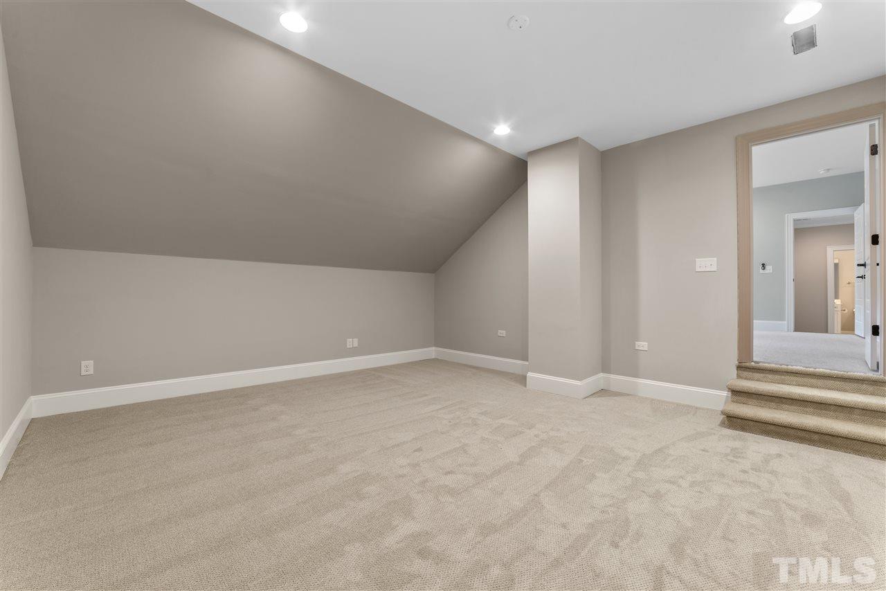 11007 Crest Mist Circle Raleigh, NC 27613 - Photo 23 of 30 Step down from the rec room into the media room/theater, wired for surround sound.