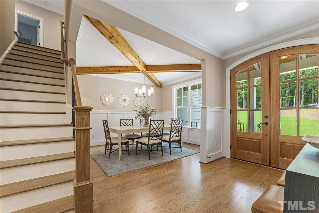 11007 Crest Mist Circle Raleigh, NC 27613 - Photo 29 of 30 Arched, double wood doors greet you. Enter and you will immediately notice the attention to detail that has been taken in this home with carefully crafted millwork, cove moldings, shiplap, gorgeous hardwoods, open floor plan...so many wonderful features.
