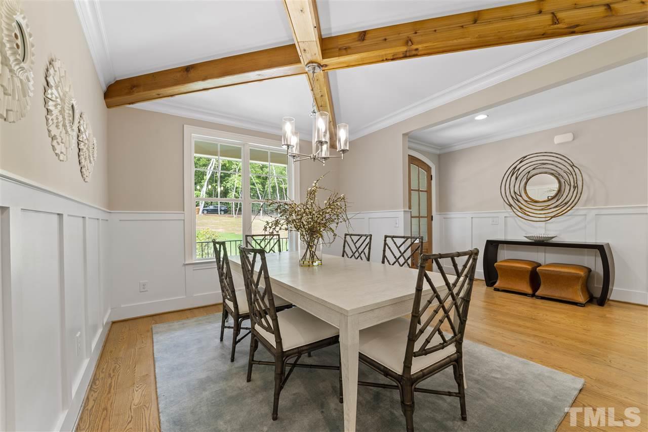 11007 Crest Mist Circle Raleigh, NC 27613 - Photo 4 of 30 Not only is there a craftsman style wainscoting but architectural style wood beams cross the ceiling for a dramatic effect.