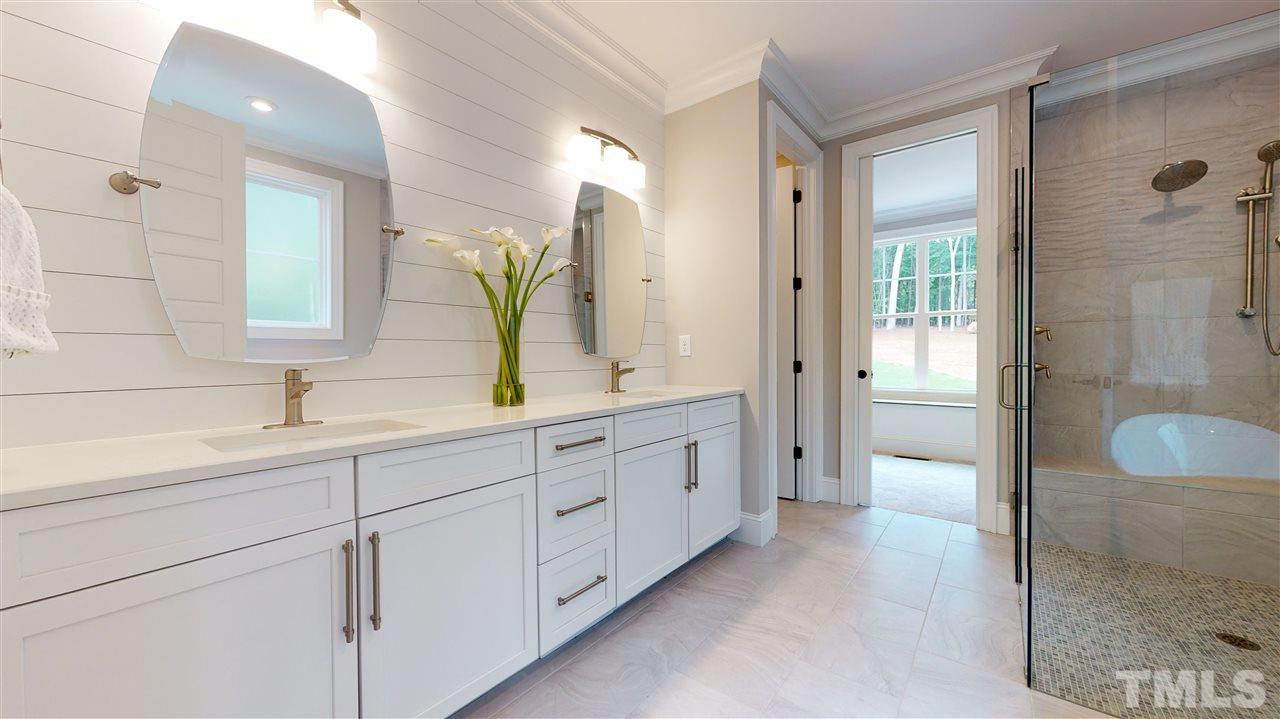 11007 Crest Mist Circle Raleigh, NC 27613 - Photo 8 of 30 Ship Lap highlights the wall behind the mirrors in the master bath. There is plenty of cabinet space. The counters are quartz. The bath has a true spa-like feel, with a separate water closet.