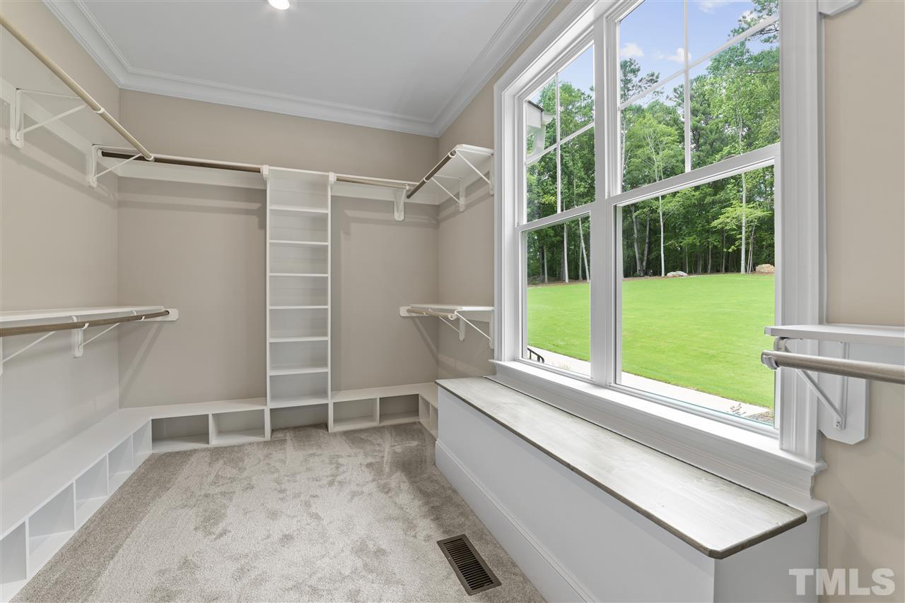 11007 Crest Mist Circle Raleigh, NC 27613 - Photo 9 of 30 The master closet was thoughtfully planned with shoe cubbies, shelves and hanging space. It even has window seat with storage.