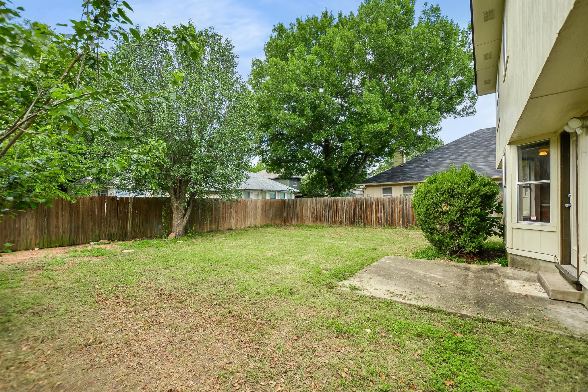 1008 Double File Trail Round Rock, TX 78665 - Photo 19 of 20 A spacious backyard provides ample green space and a concrete patio for outdoor enjoyment.