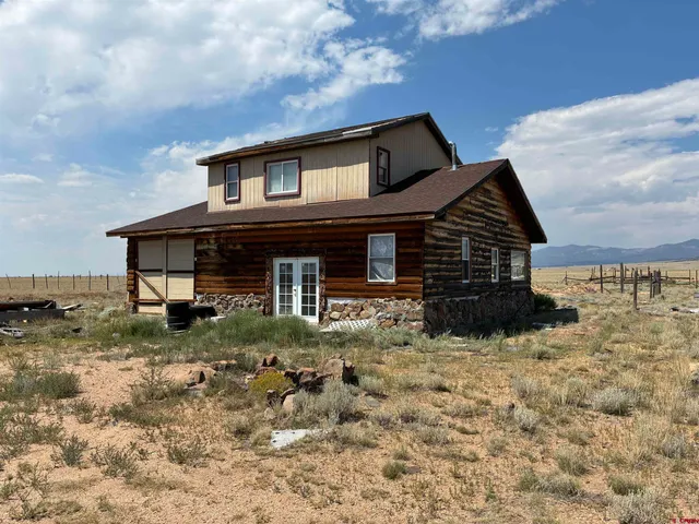 a view of a house with wooden fence