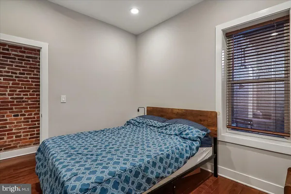 a bedroom with a bed and window