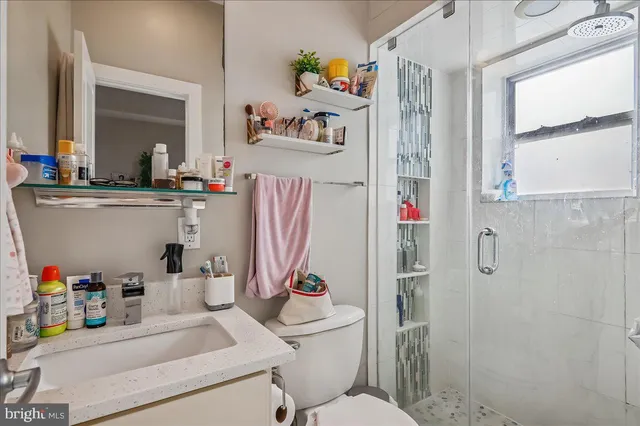a bathroom with a sink toilet and shower
