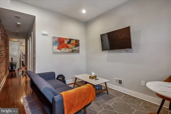 a work room with furniture and a flat screen tv