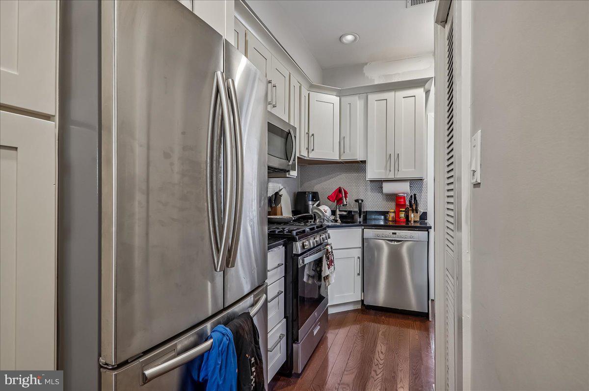 30 Hanover Place Northwest, Unit 1 Washington, DC 20001 - Photo 8 of 20 a kitchen with stainless steel appliances a refrigerator sink and cabinets