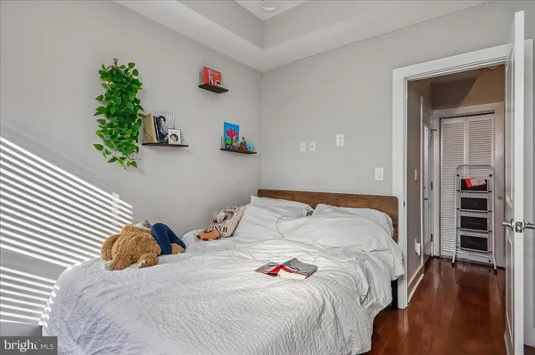 a bedroom with a bed and a potted plant