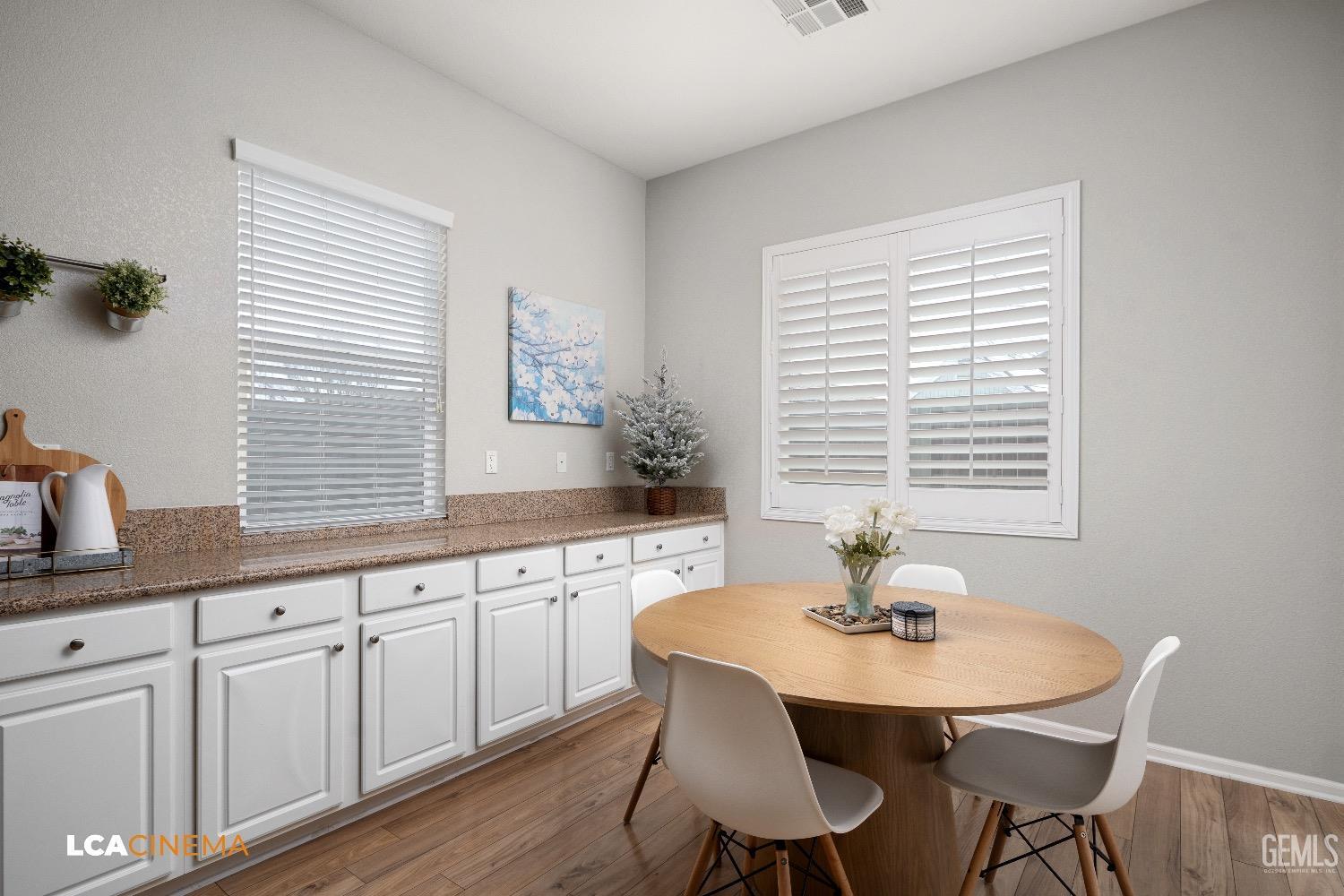 Undisclosed Address Bakersfield, CA 93314 - Photo 14 of 29 a kitchen with white cabinets a table and chairs