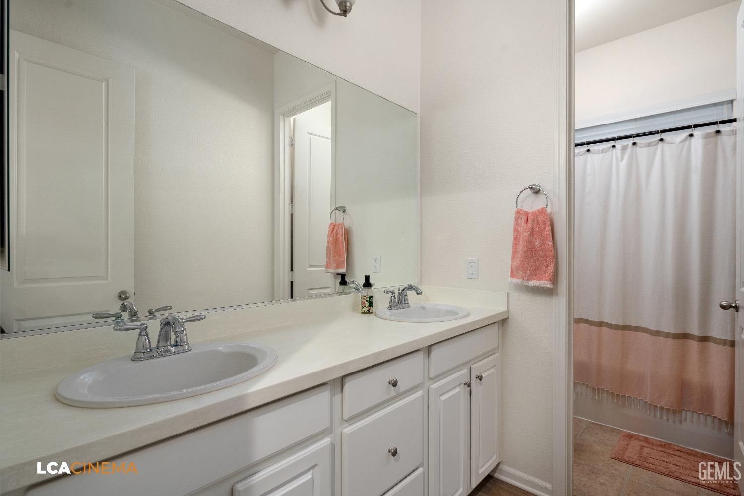 Undisclosed Address Bakersfield, CA 93314 - Photo 22 of 29 a bathroom with a sink and a mirror