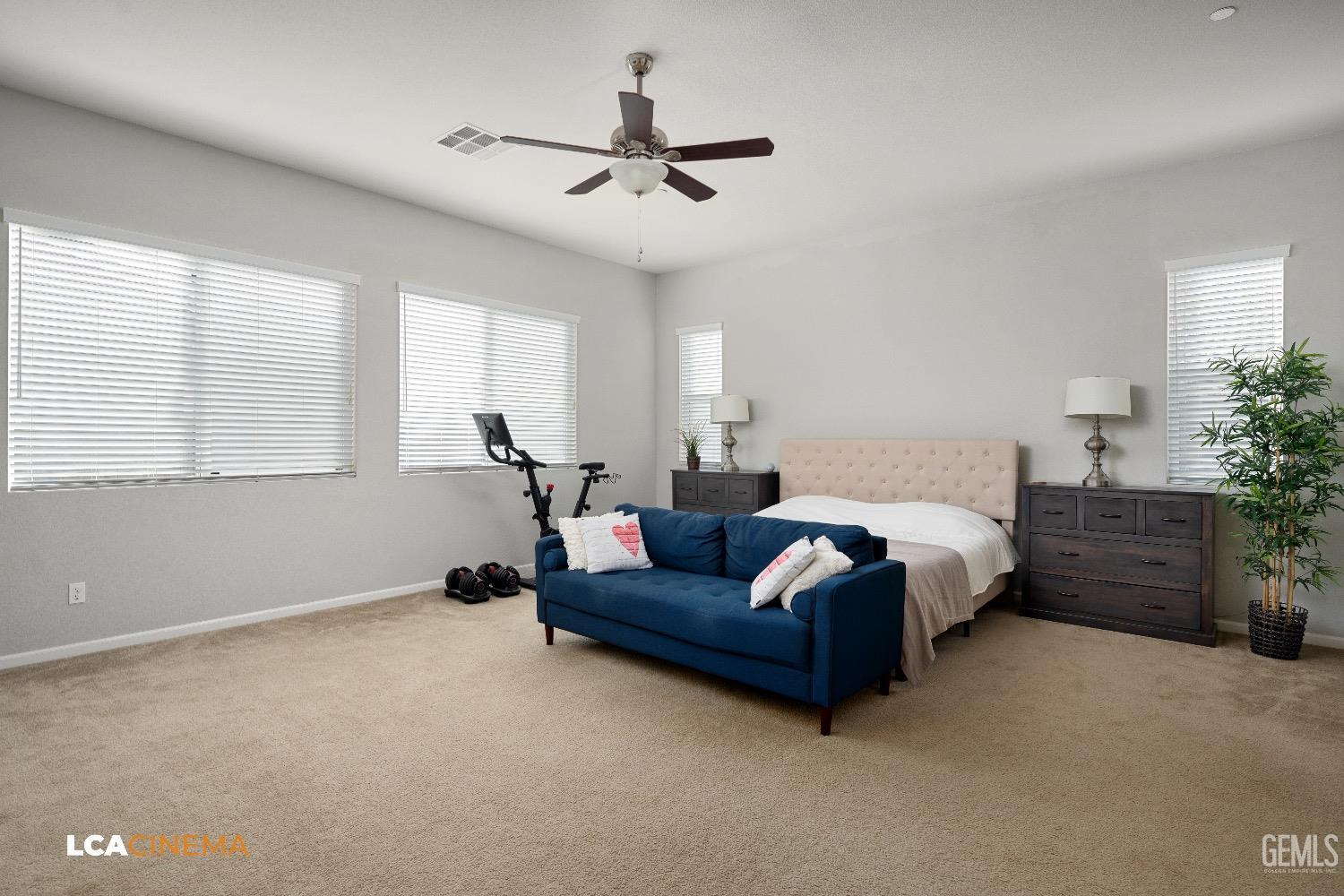 Undisclosed Address Bakersfield, CA 93314 - Photo 24 of 29 a spacious bedroom with a bed chandelier and a window